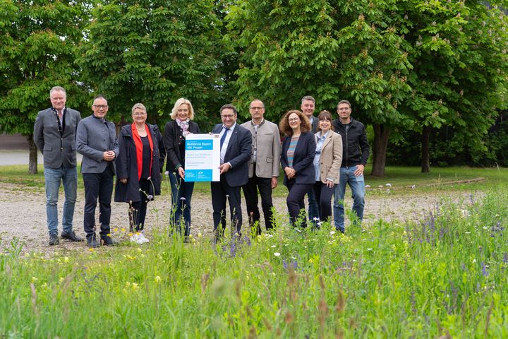 Bayerns Wirtschaftsstaatssekretär Tobias Gotthardt hat heute die 100. Förderurkunde aus dem Förderprogramm BioWärme Bayern überreicht. Das Bild zeigt ihn mit Zuwendungsempfängerin Brigitte Koch vom Gutshof Greif bei Taufkirchen sowie weiteren Projektverantwortlichen und Vertretern der lokalen Politik. Foto: StMWi/Bastian Brummer