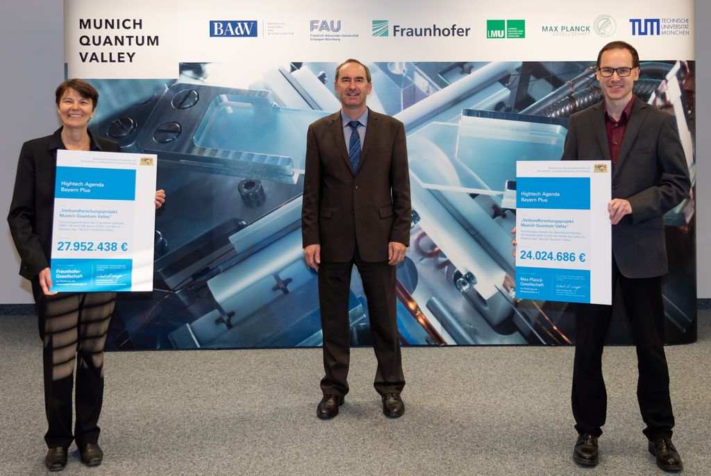 Staatsminister Hubert Aiwanger übergibt Förderbescheid an Frau Prof. Dr. Claudia Eckert (Institutsleiterin von Fraunhofer AISEC) und an Herrn Prof. Dr. Florian Marquardt (Direktor des Max-Planck Instituts für die Physik des Lichts, Erlangen). (Fotonachweis: StMWi / E. Neureuther)