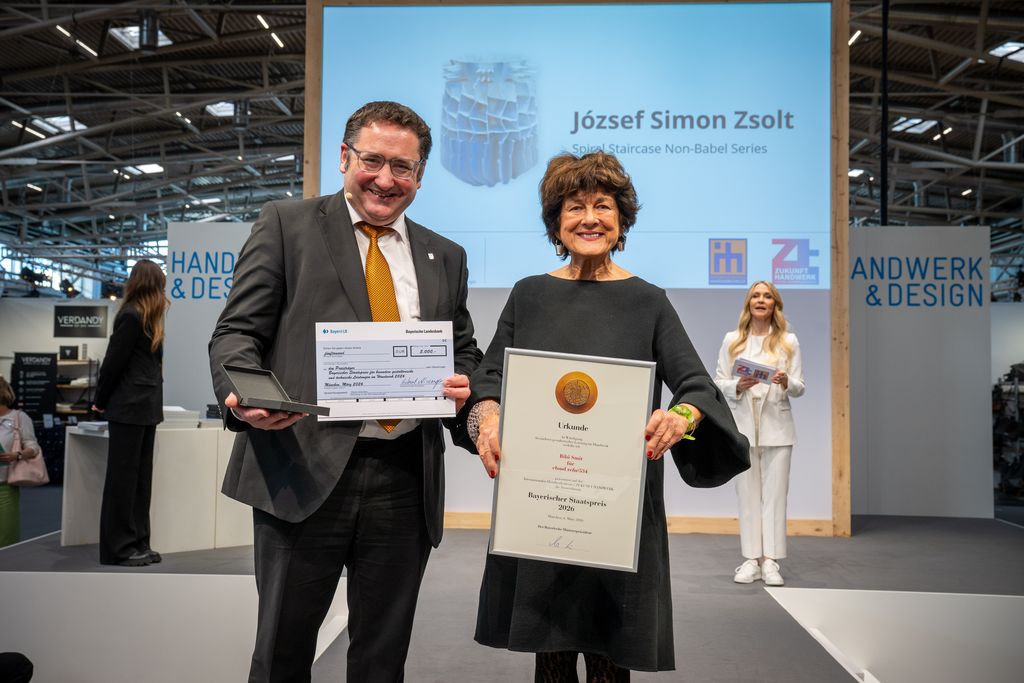 Bayerns Wirtschaftsstaatssekretär Tobias Gotthardt übergibt den Staatspreis.